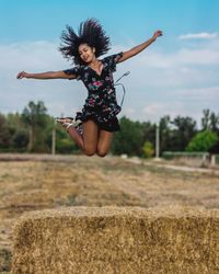 Young woman jumping on field