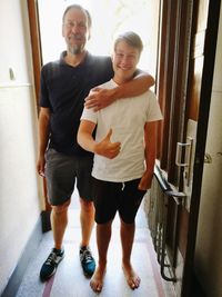 Portrait of happy friends standing on floor