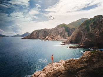 Scenic view of sea and mountain against sky
