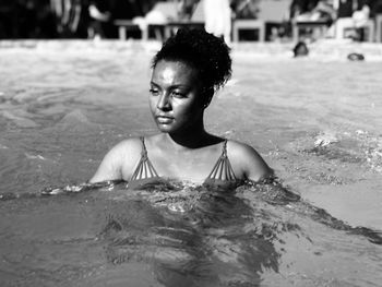 Woman looking away while swimming in pool