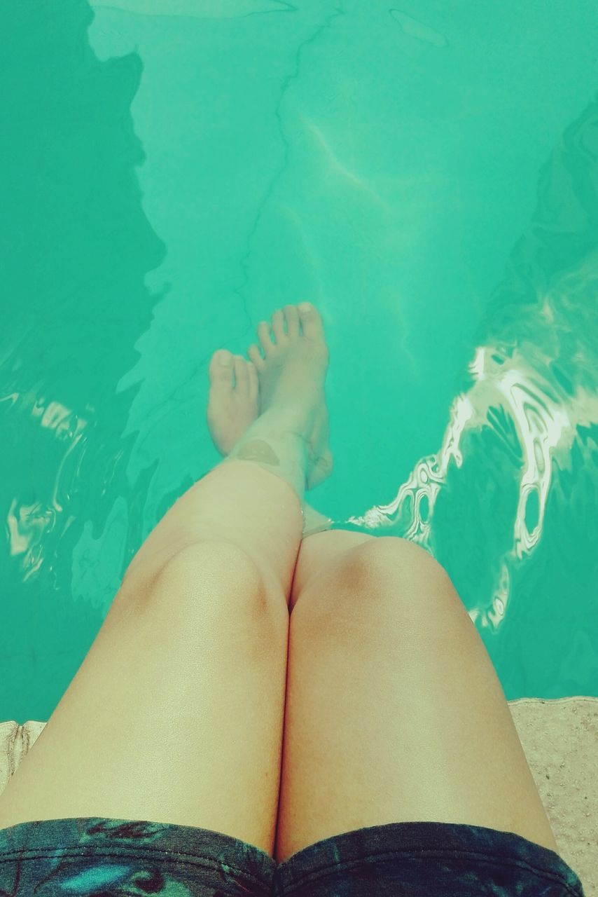 lifestyles, low section, person, leisure activity, water, people, barefoot, swimming pool, blue, personal perspective, relaxation, young adult, young women, vacations, sea, human foot, beach