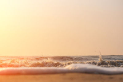Scenic view of sea against clear sky during sunset