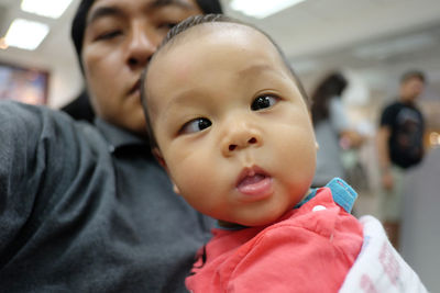 Portrait of baby with father in hospital