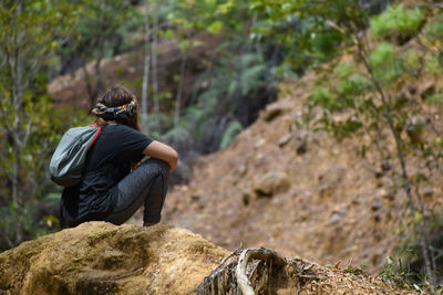 Rear view of man on rock