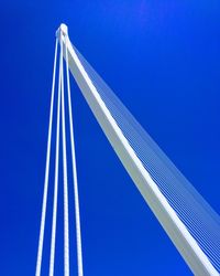 Low angle view of bridge against clear blue sky