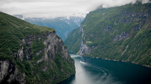 High angle view of fjord amidst mountains against sky 