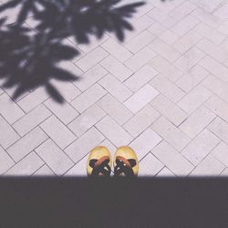 High angle view of sandals on street during sunny day