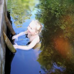 Close-up of smiling girl by lake