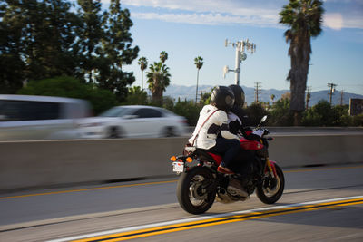 Person riding motorcycle on road