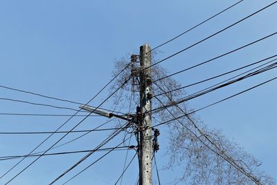 Low angle view of electricity pylon against sky