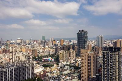 High angle view of buildings in city against sky