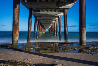 Pier over sea against sky