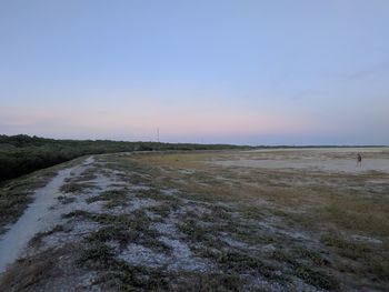 Scenic view of beach against sky during sunset