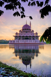 Reflection of building in lake at sunset