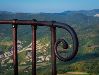 Close-up of metal railing against sky