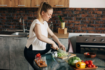 Sports woman cooking healthy eat at home