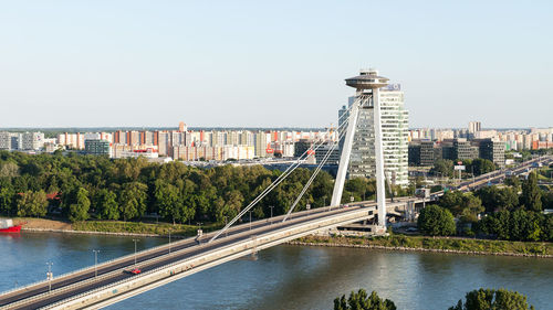 View of city at waterfront against clear sky