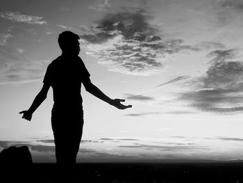 Silhouette people on beach against sky