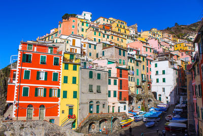 Multi colored buildings in city against clear sky