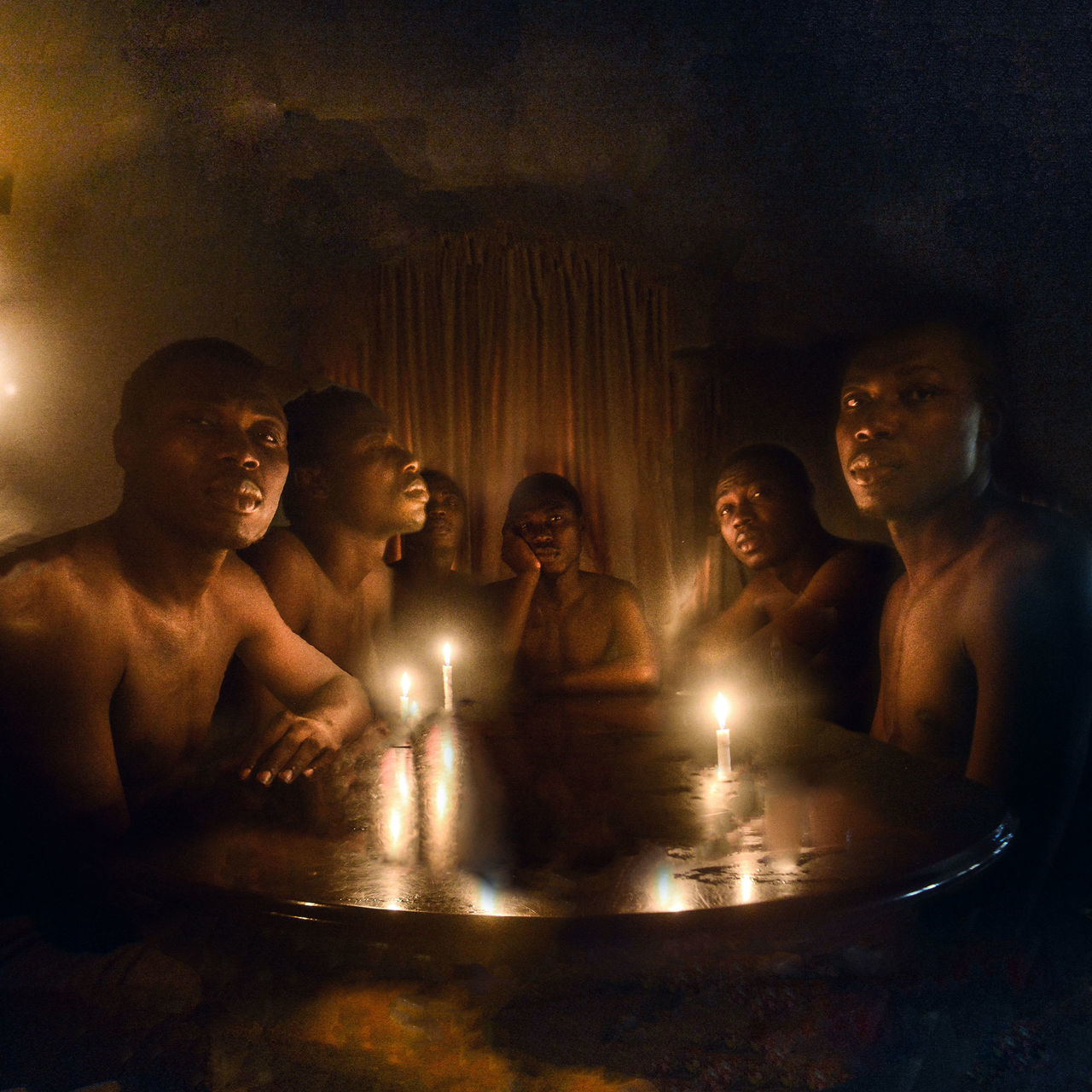 group of people, men, sitting, illuminated, real people, indoors, lifestyles, people, religion, boys, spirituality, males, young men, leisure activity, adult, candle, togetherness, young adult, shirtless, night