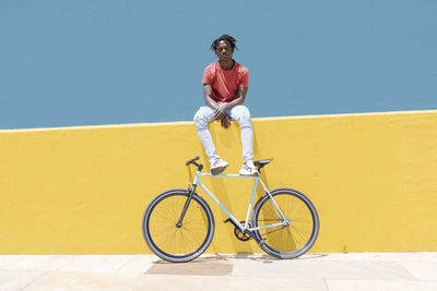 African american guy resting near bicycle