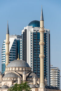 Low angle view of skyscrapers against clear sky