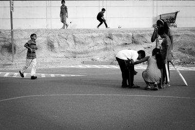 Rear view of woman standing on road