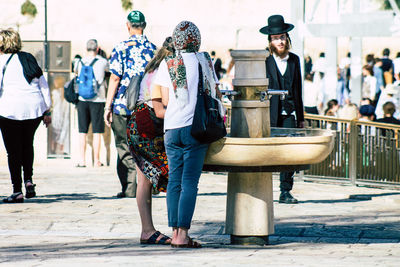 People on footpath in city