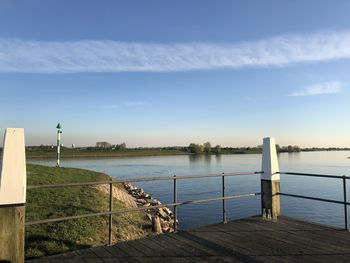 Pier over lake against sky