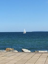 Scenic view of sea against clear blue sky