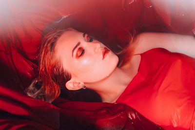 High angle view of young woman sleeping in bathtub