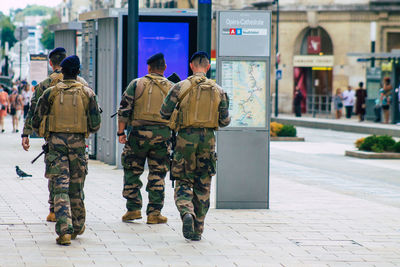 Rear view of people walking in city