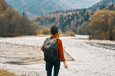 Rear view of man walking on shore