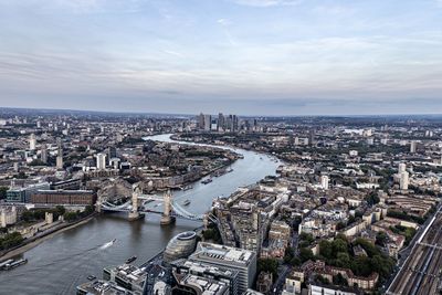 High angle view of cityscape by sea against sky