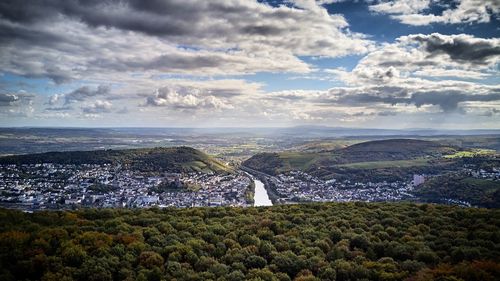 Aerial view of city against cloudy sky