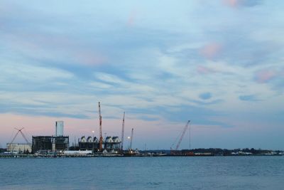 Commercial dock by sea against sky