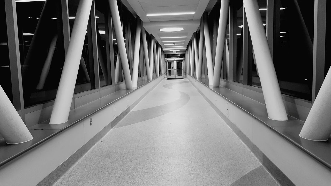 indoors, the way forward, empty, corridor, diminishing perspective, absence, in a row, ceiling, vanishing point, architecture, architectural column, built structure, flooring, narrow, long, no people, column, lighting equipment, tiled floor, illuminated