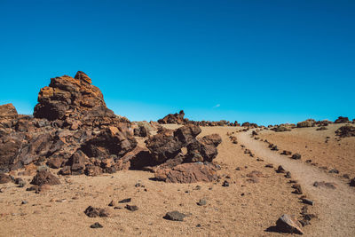 Rock formations in desert against clear blue sky