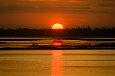 Light trails on road at sunset