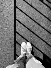 Low section of man standing on footpath