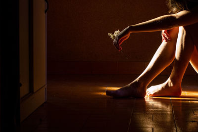 Low section of woman relaxing on floor