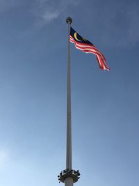 Low angle view of crane against blue sky