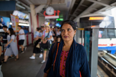 Woman looking away at subway station