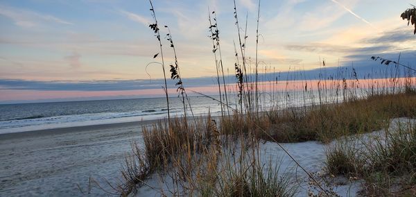 Scenic view of ocean against sky during sunset