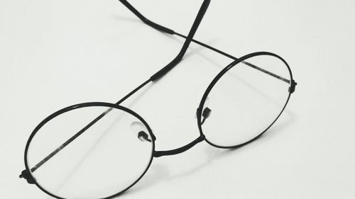 High angle view of eyeglasses against white background