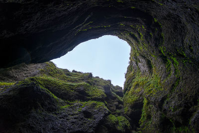 Low angle view of rock formation against sky