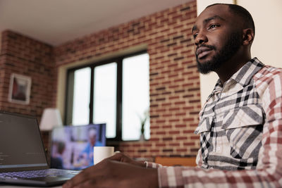 Young man using laptop at office