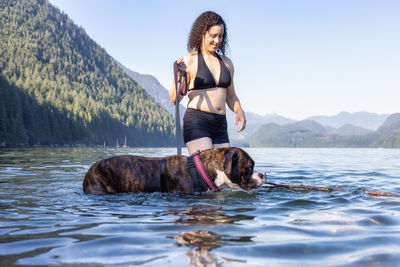 Man with dog standing in water