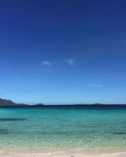Scenic view of sea against blue sky