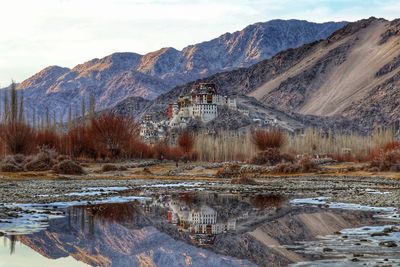 Scenic view of lake and mountains against sky